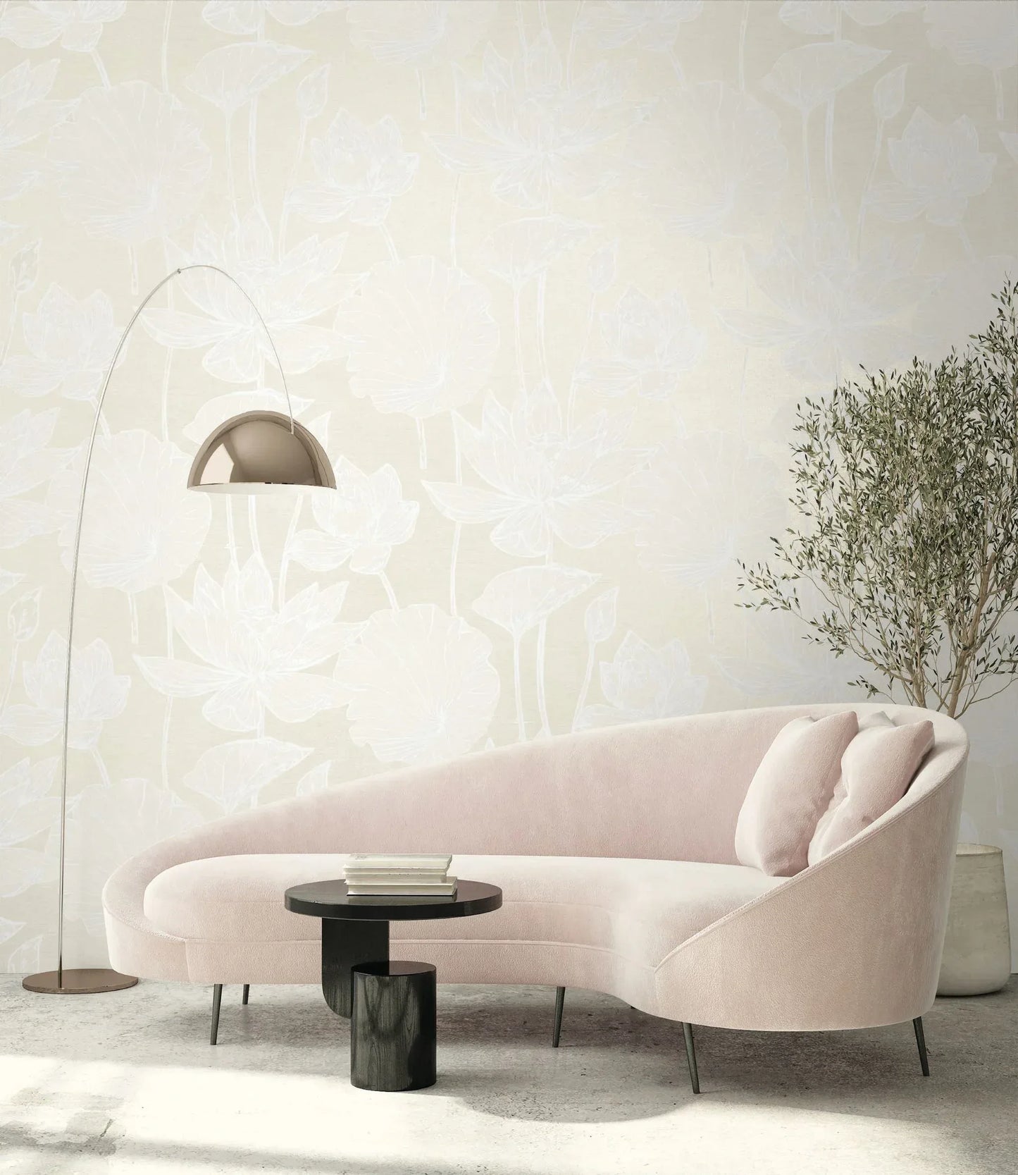 Curved pale pink sofa, black coffee table, lamp, plant, and two cushions against Lily Flower Wallpaper.