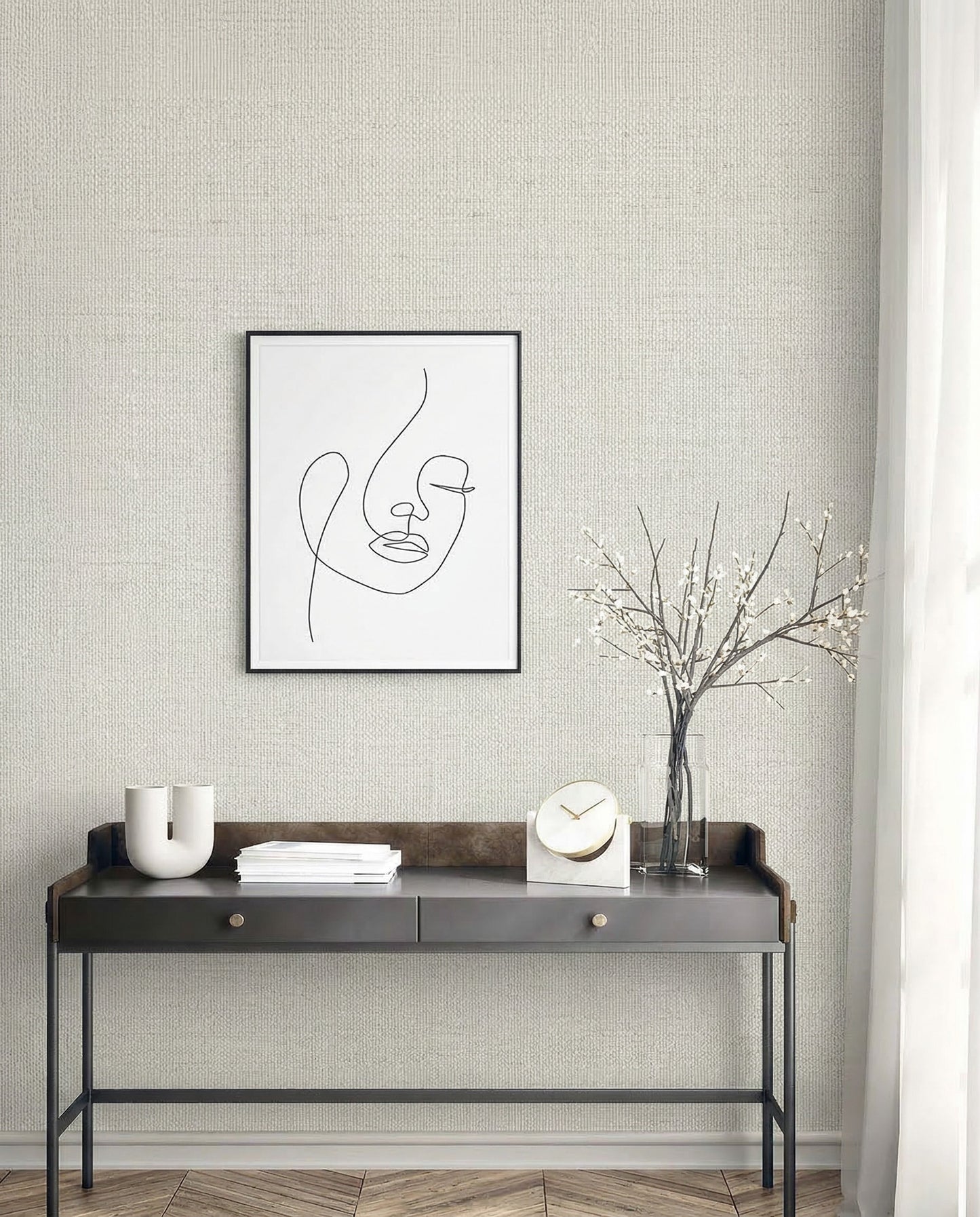 Minimalist console table with decor, vase, and abstract face art on a Faux Paperweave Commercial Vinyl wall.