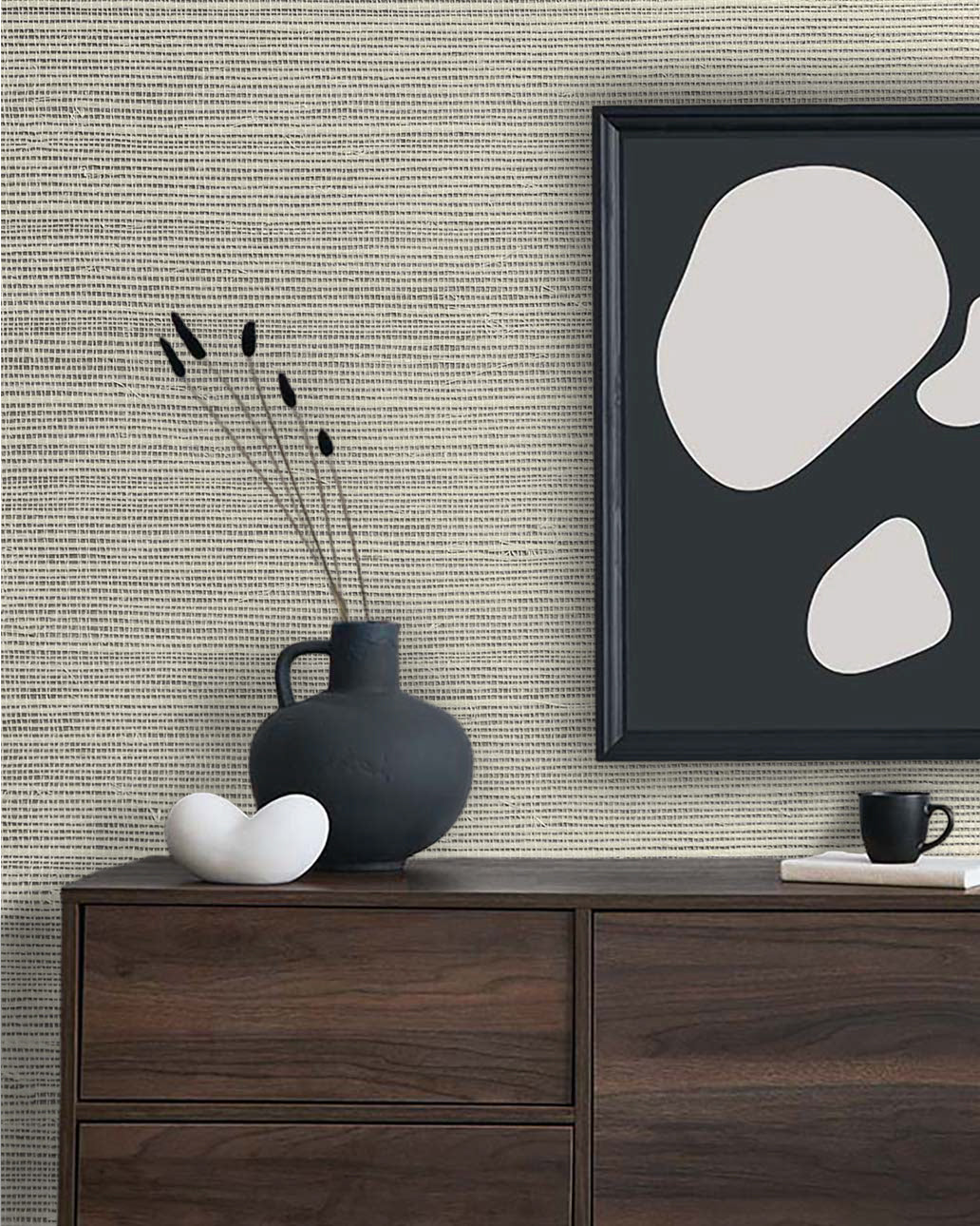 A modern dresser with a black vase, abstract art, and cup stands out against Sisal Texture Grasscloth Naturals.