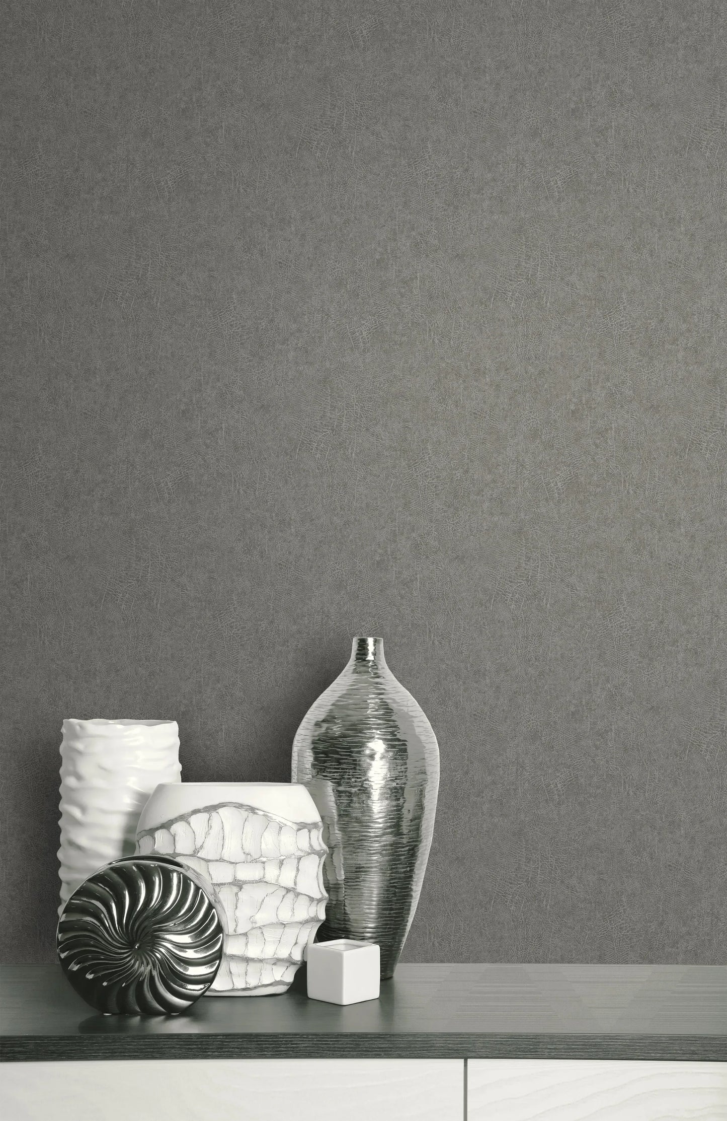 White and silver vases on a modern cabinet against textured gray Leather Effect Imitation Commercial Vinyl wallcovering.