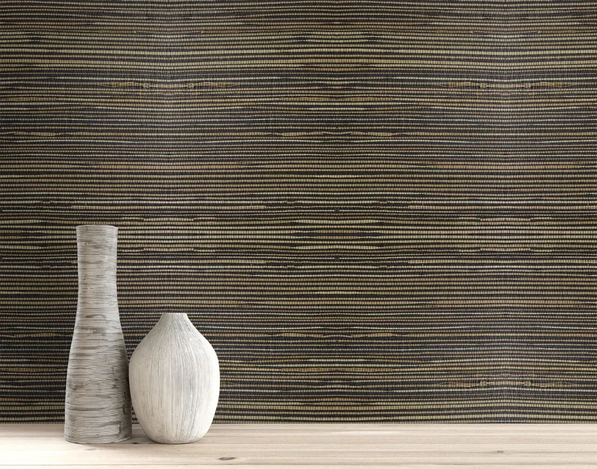 Two white ceramic vases on light wood with Straw Texture Grasscloth Naturals wallpaper in the background.