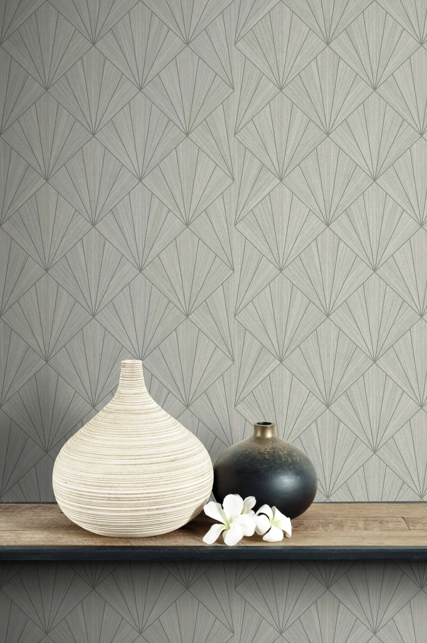 Two vases and white flowers on a shelf, set against Art Deco Geo Commercial Vinyl gray geometric wallpaper.