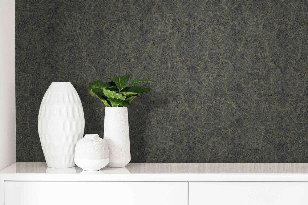 White vases and a green plant on a white surface, set against Jungle Metallic Leaf Peel Stick wallpaper.