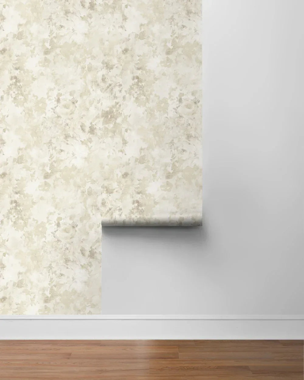 A roll of Watercolor Floral Peel Stick wallpaper partially applied to a white wall above a wooden floor.