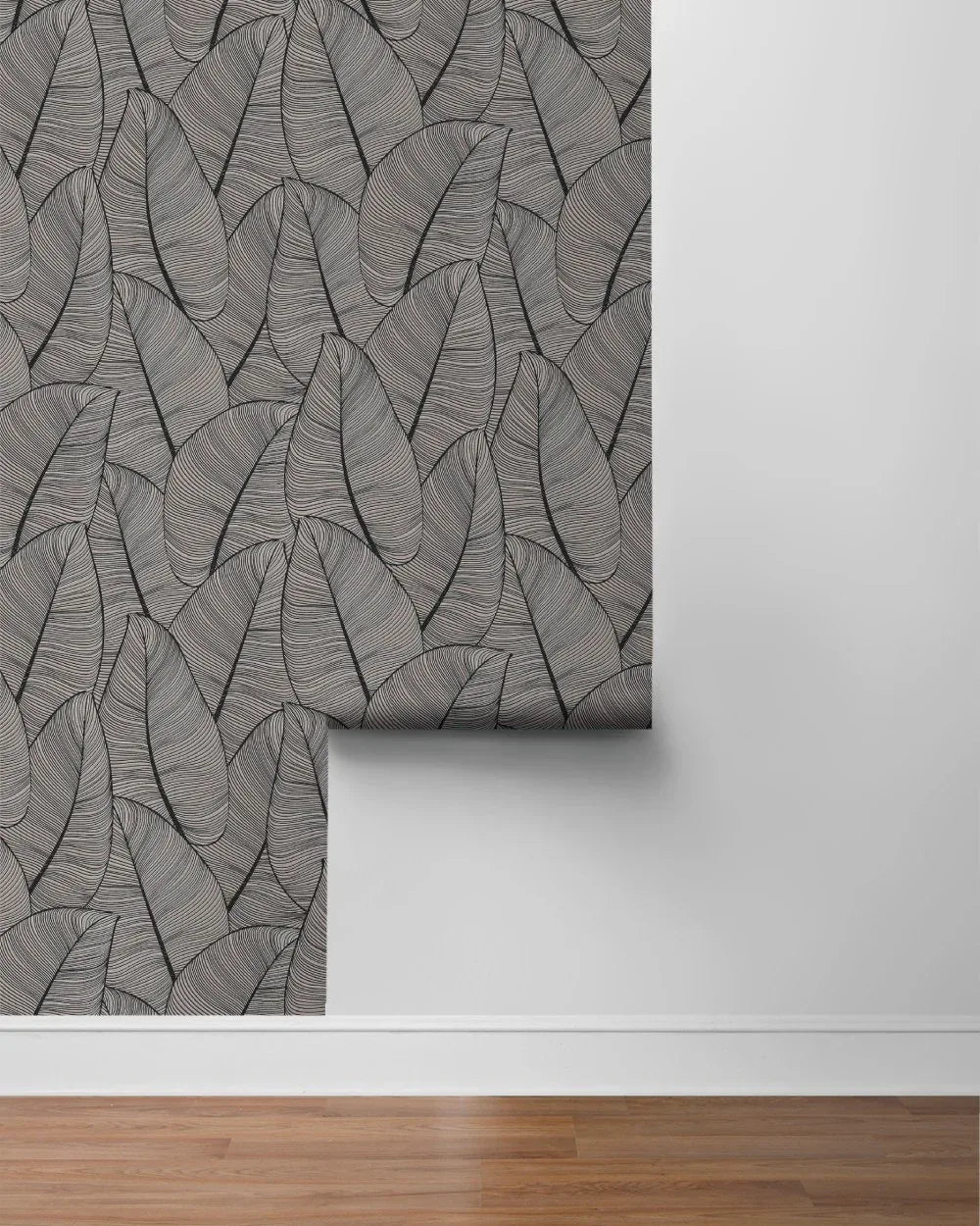 Modern Metallic Leaf Peel Stick wallpaper decorates a white wall above a hardwood floor.