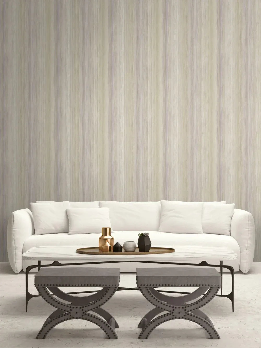 Minimalist living room with a white sofa, two ottomans, and Soft Stripe Wallpaper behind a round coffee table.