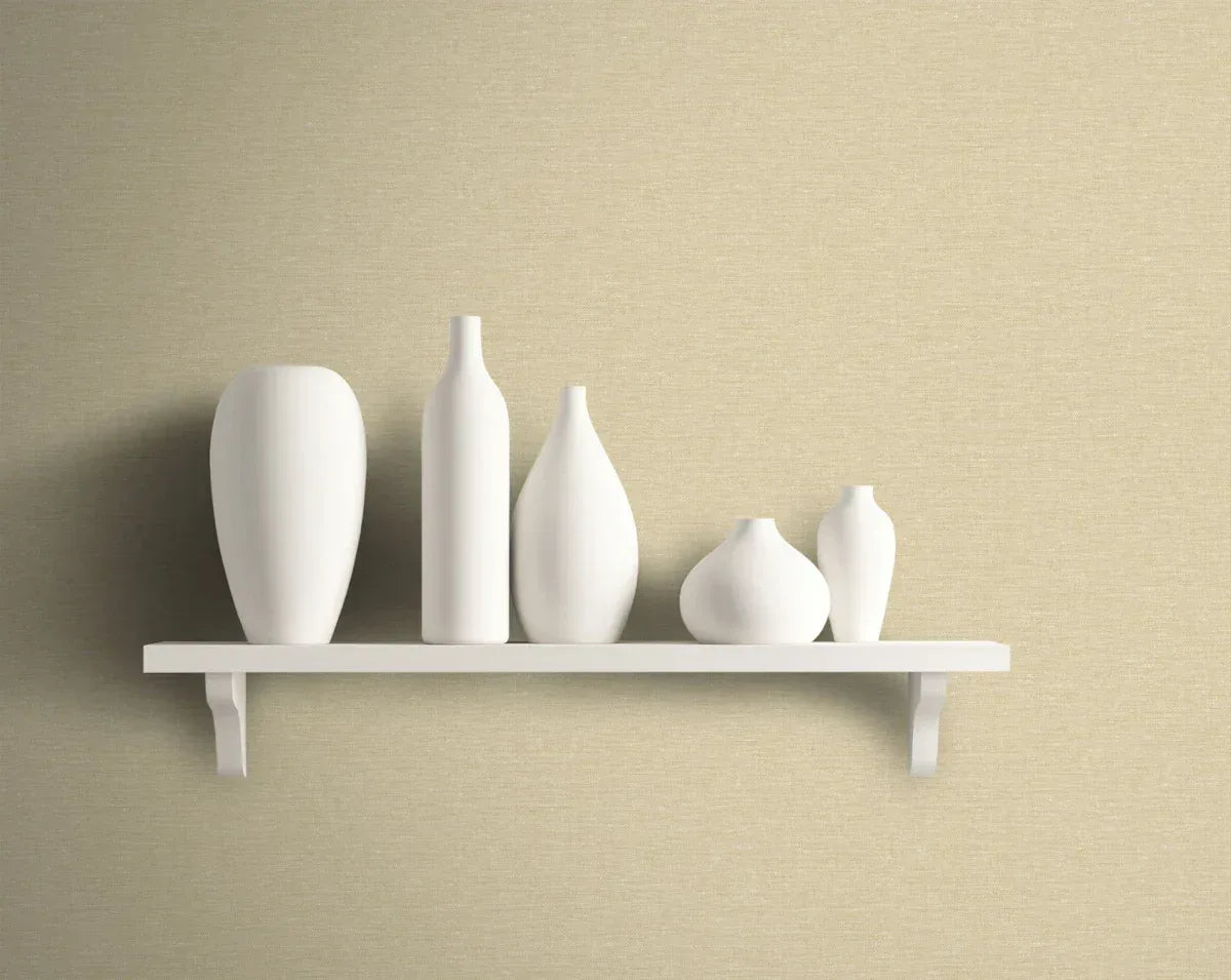 A white shelf holds five white ceramic vases against a beige wall with Texture Wallpaper.