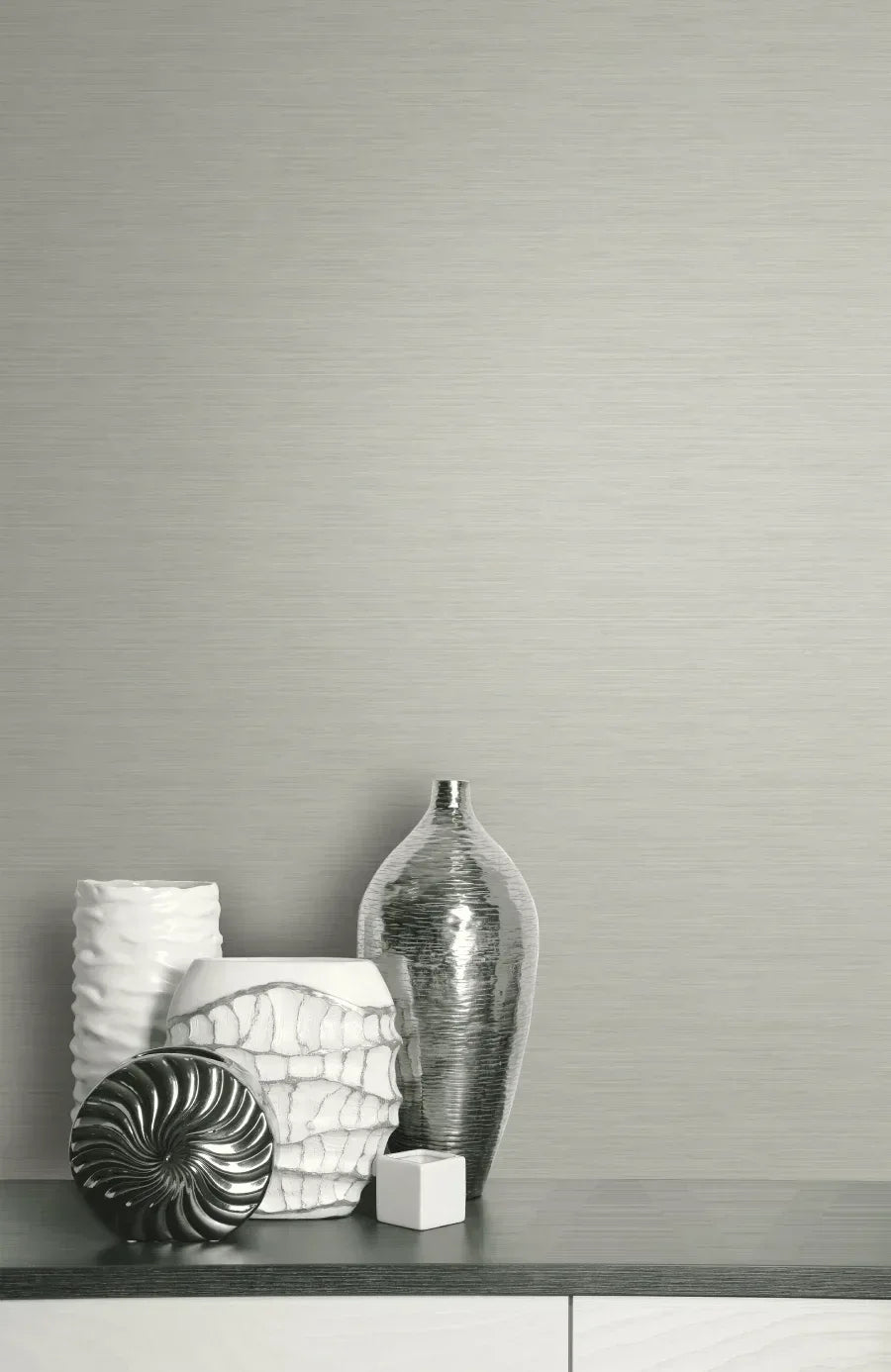 Five white and silver vases and objects displayed on a dark surface with Soft Texture Wallpaper as the backdrop.