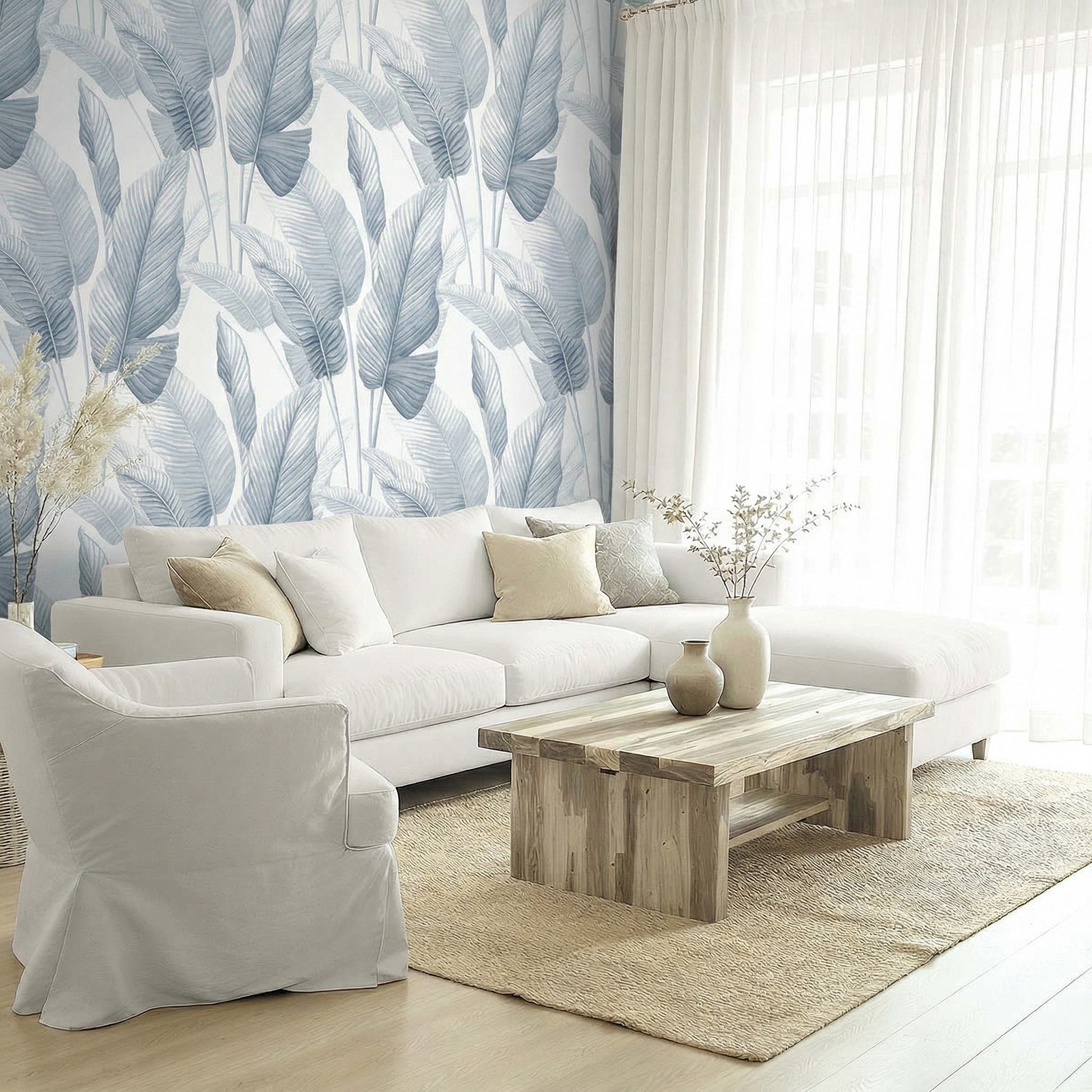 Bright living room with white sofa, wood table, and Lace Leaf Wallpaper behind sheer curtains.
