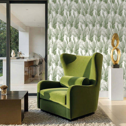 Green armchair in a modern living room with Lace Leaf Wallpaper, glass doors, and a gold abstract sculpture on a console.