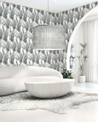 Modern living room with curved white sofa, round marble table, and Lace Leaf Wallpaper in white/off white dark gray.