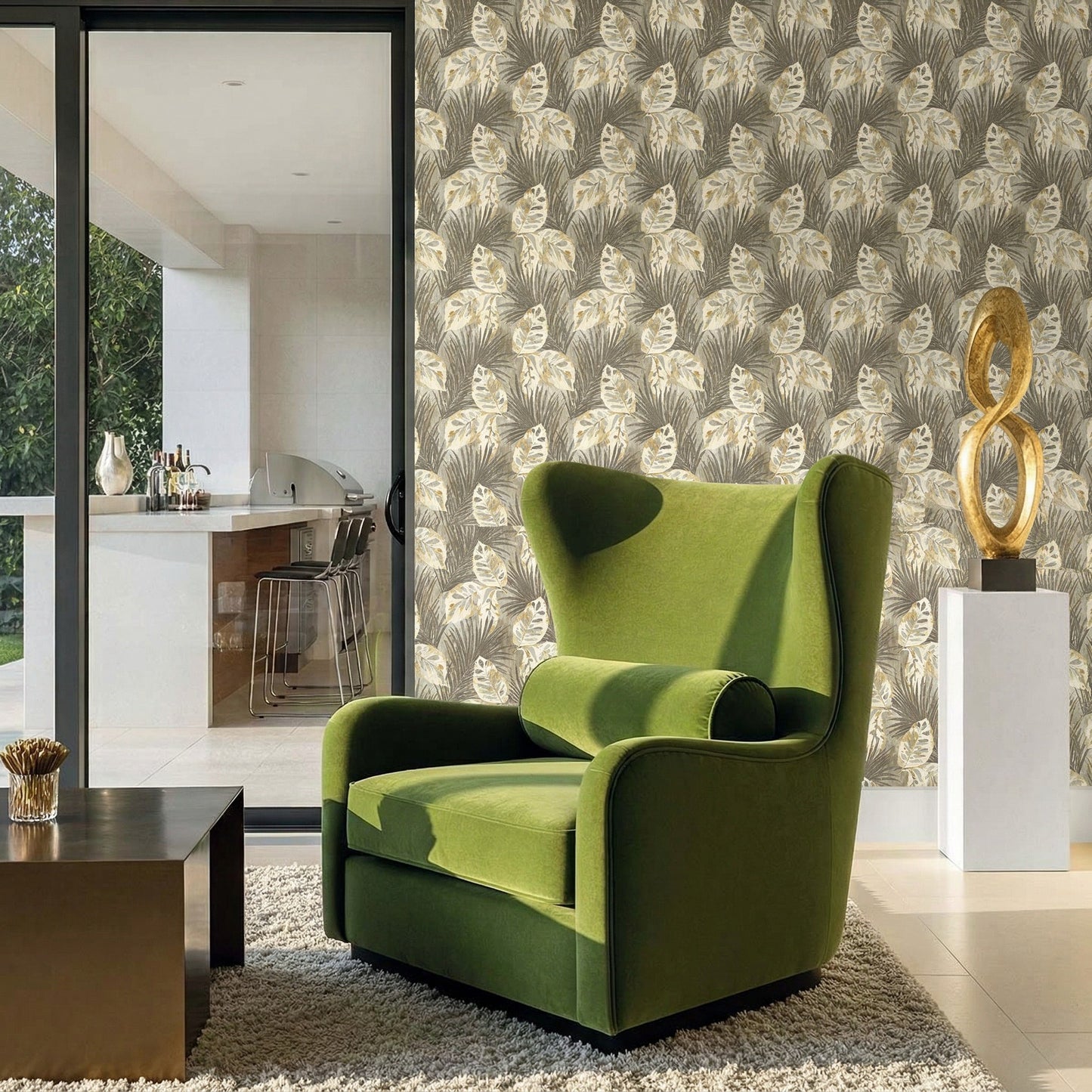 A green armchair sits near a table, with Tropical Bali Leaf Wallpaper and glass doors in the stylish room.