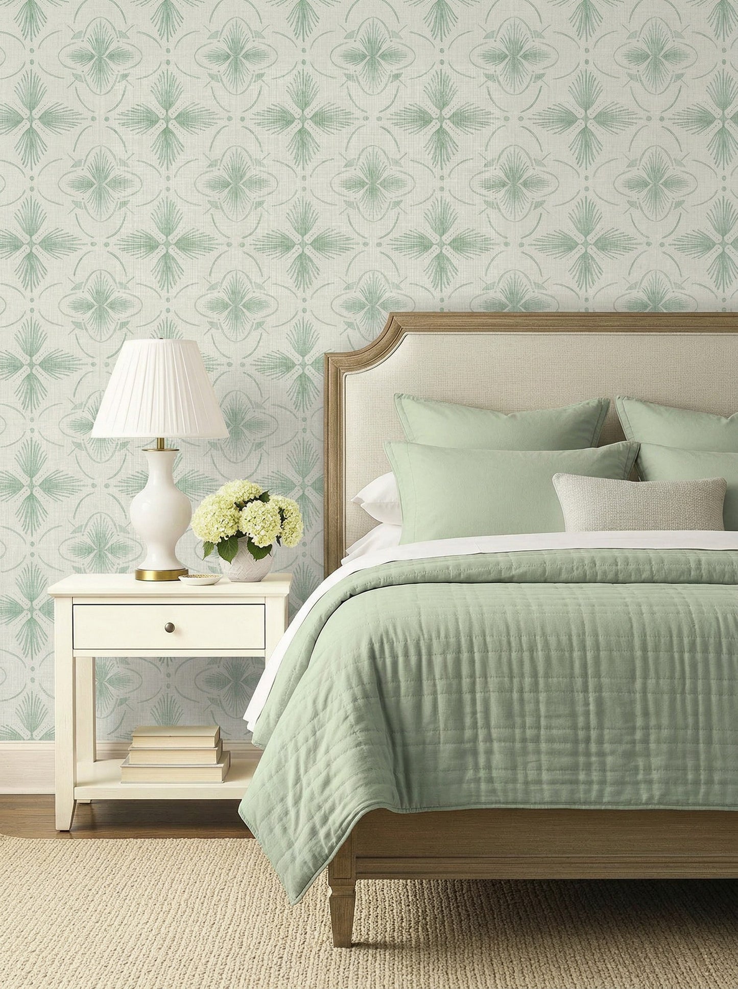A neatly made bed with green bedding, a nightstand, and Tropical Bali Essence Grasscloth Naturals wallpaper behind.