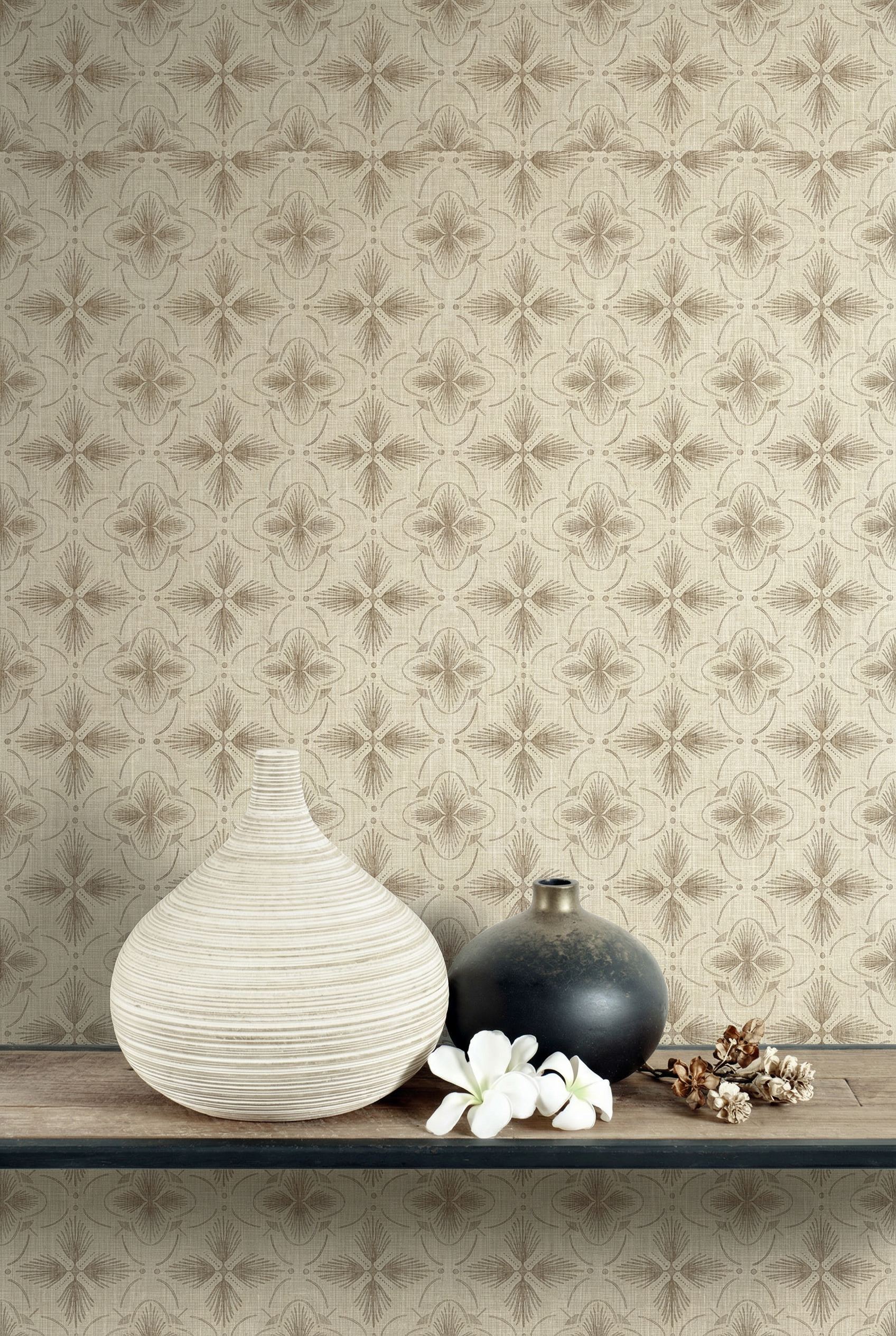 Two vases and white flowers on a wooden shelf with Tropical Bali Essence Grasscloth Naturals wallpaper in beige tones.