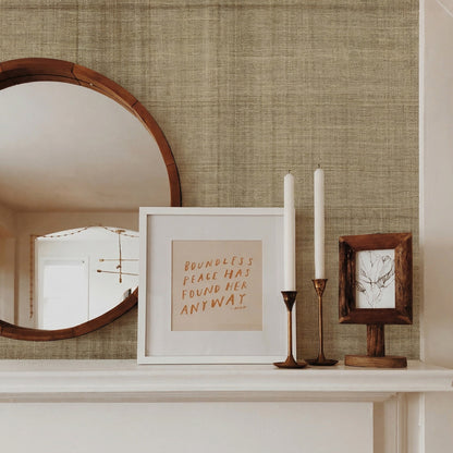 Round mirror, art, tall candlesticks, and branch drawing on a mantel against Textured Plaid Commercial Vinyl wall.