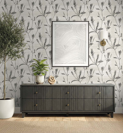 A dark wood sideboard with plants and decor sits against Botanical Bali Leaf Commercial Vinyl wallpaper.