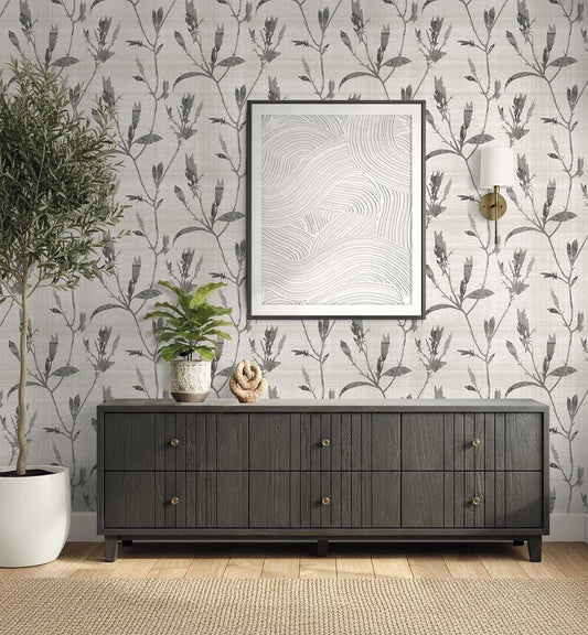 A dark wood sideboard with plants and decor sits against Botanical Bali Leaf Commercial Vinyl wallpaper.