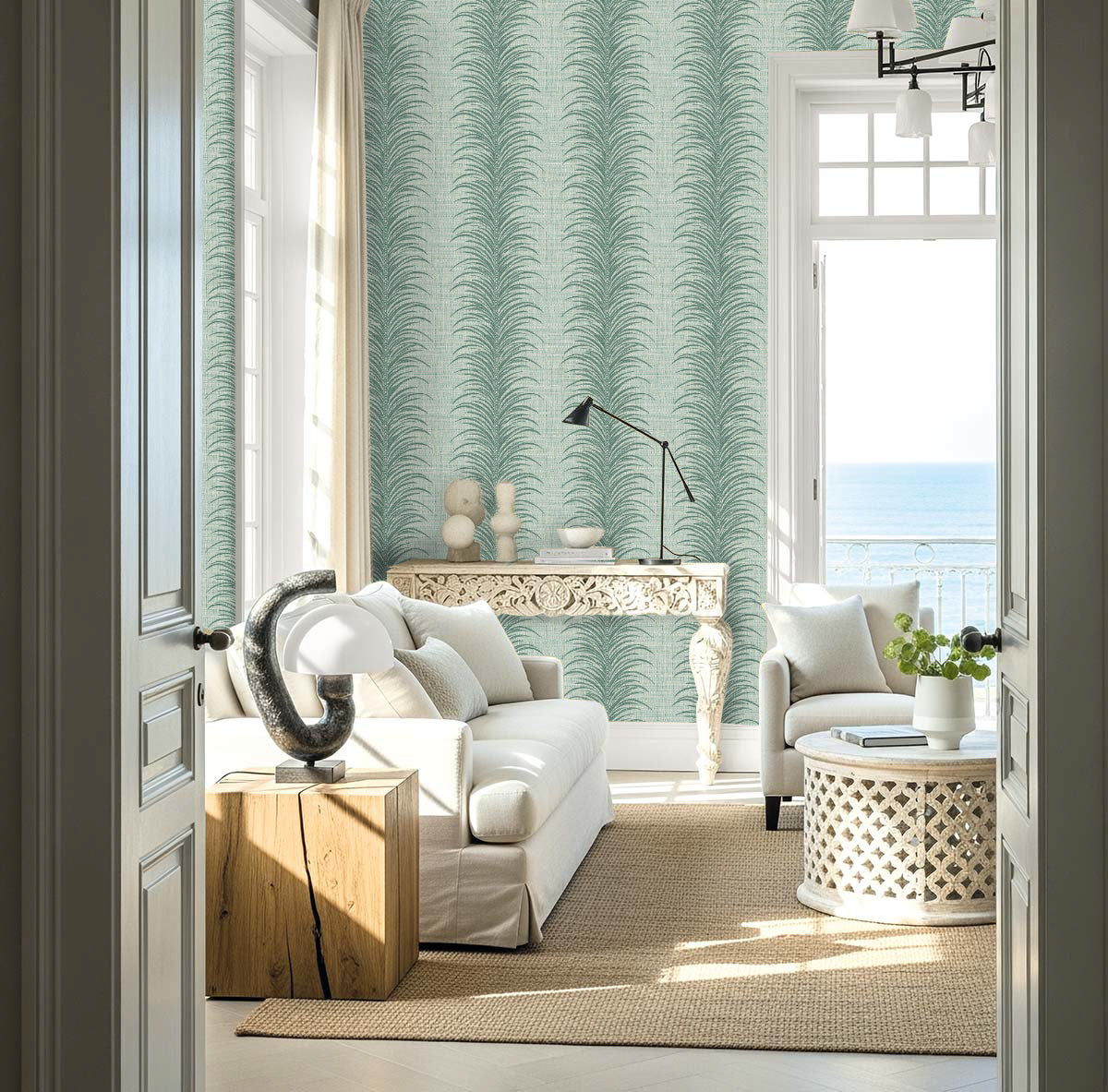 Bright coastal modern space featuring Tropical Bali Leaf Stripe Commercial Vinyl, white furniture, and an ocean view.