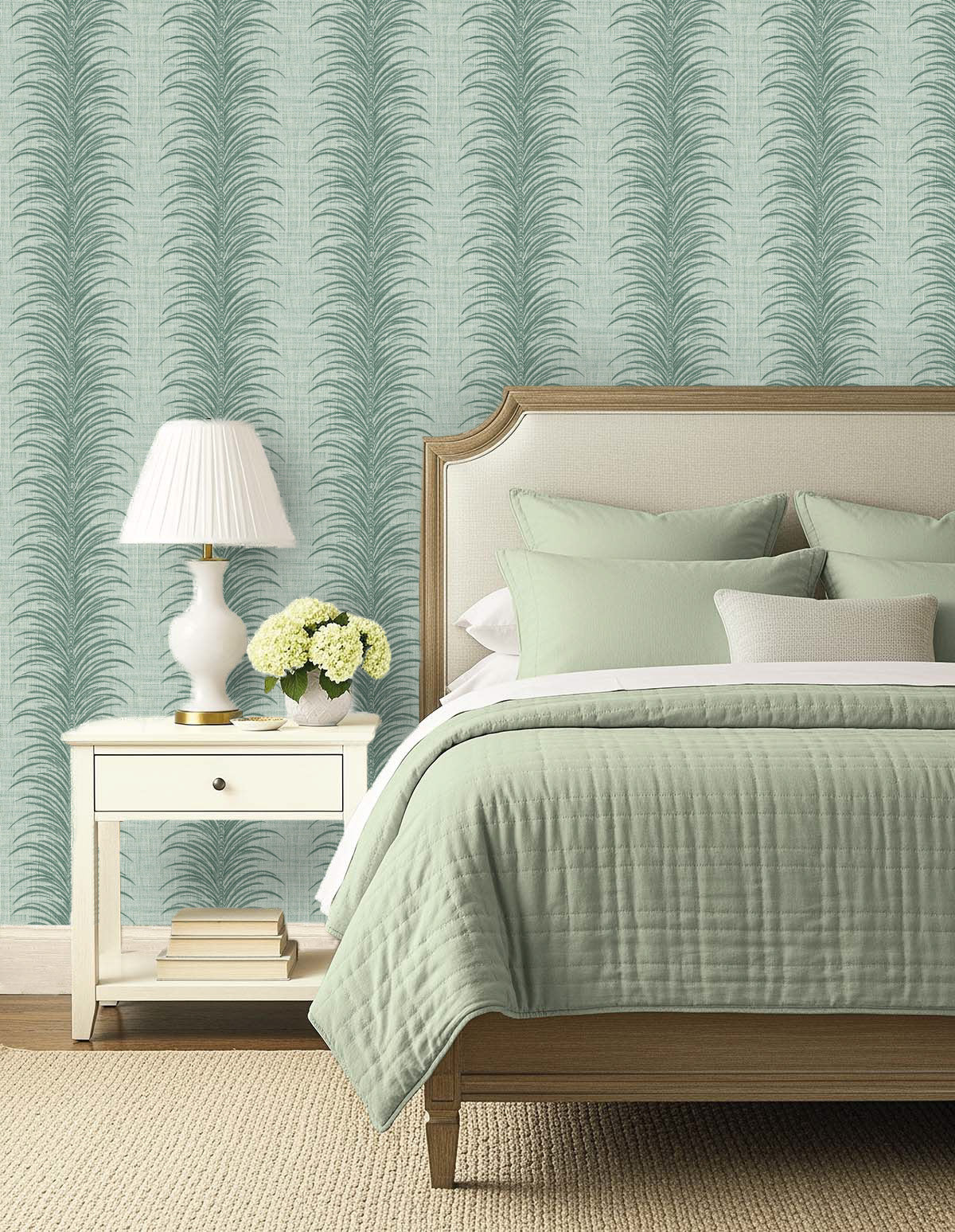 A bed with sage green bedding, a nightstand, and Tropical Bali Leaf Stripe Commercial Vinyl wallpaper for modern style.