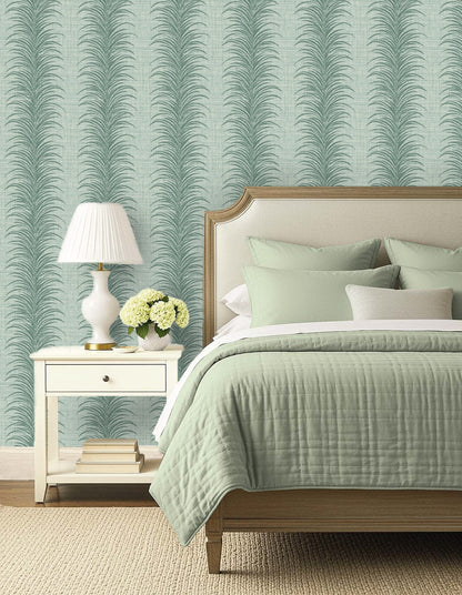 A bed with sage green bedding, a nightstand, and Tropical Bali Leaf Stripe Commercial Vinyl wallpaper for modern style.