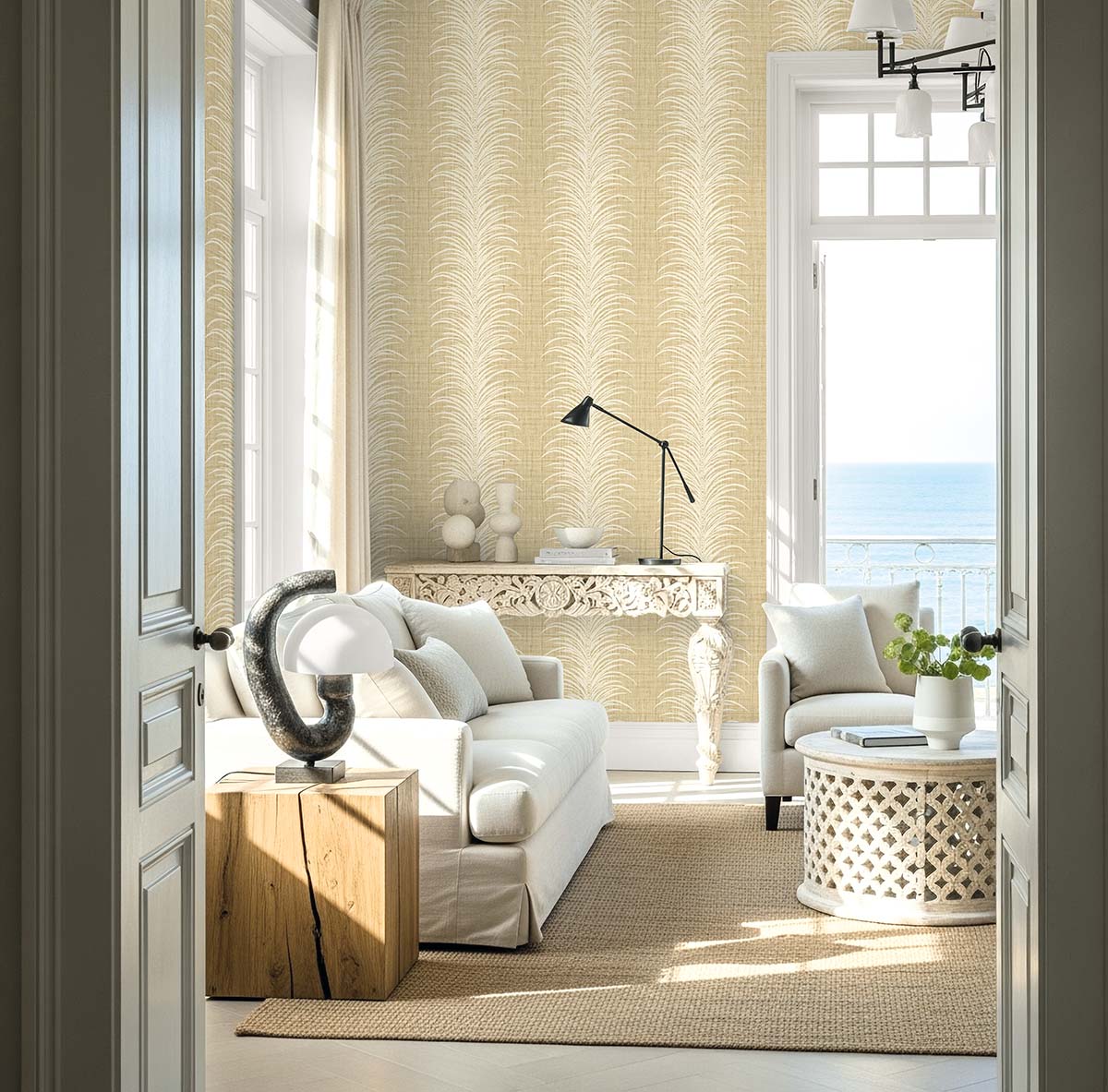 Bright, elegant living room with white furniture and Tropical Bali Leaf Stripe Commercial Vinyl wallpaper, ocean view.