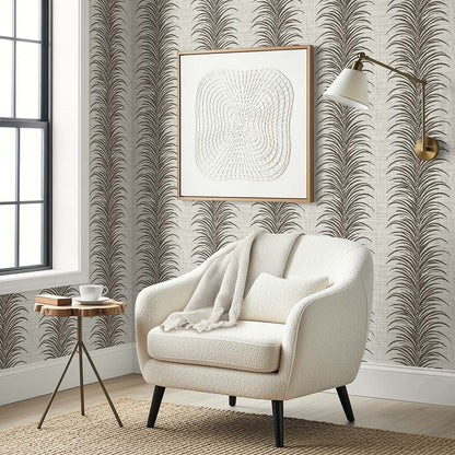 Cozy white armchair, blanket, wall art, and lamp in a stylish room with Tropical Bali Leaf Stripe Commercial Vinyl wallpaper.