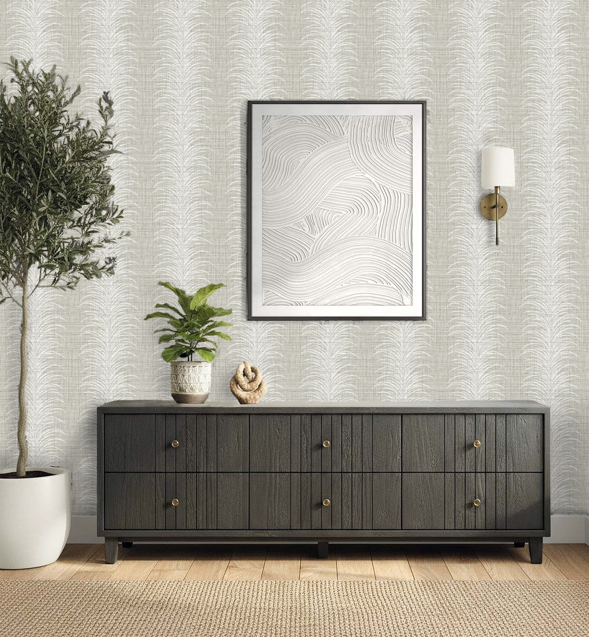 A modern console table with plants, decor, wall art, and a sleek sconce set against Tropical Bali Leaf Stripe Vinyl.
