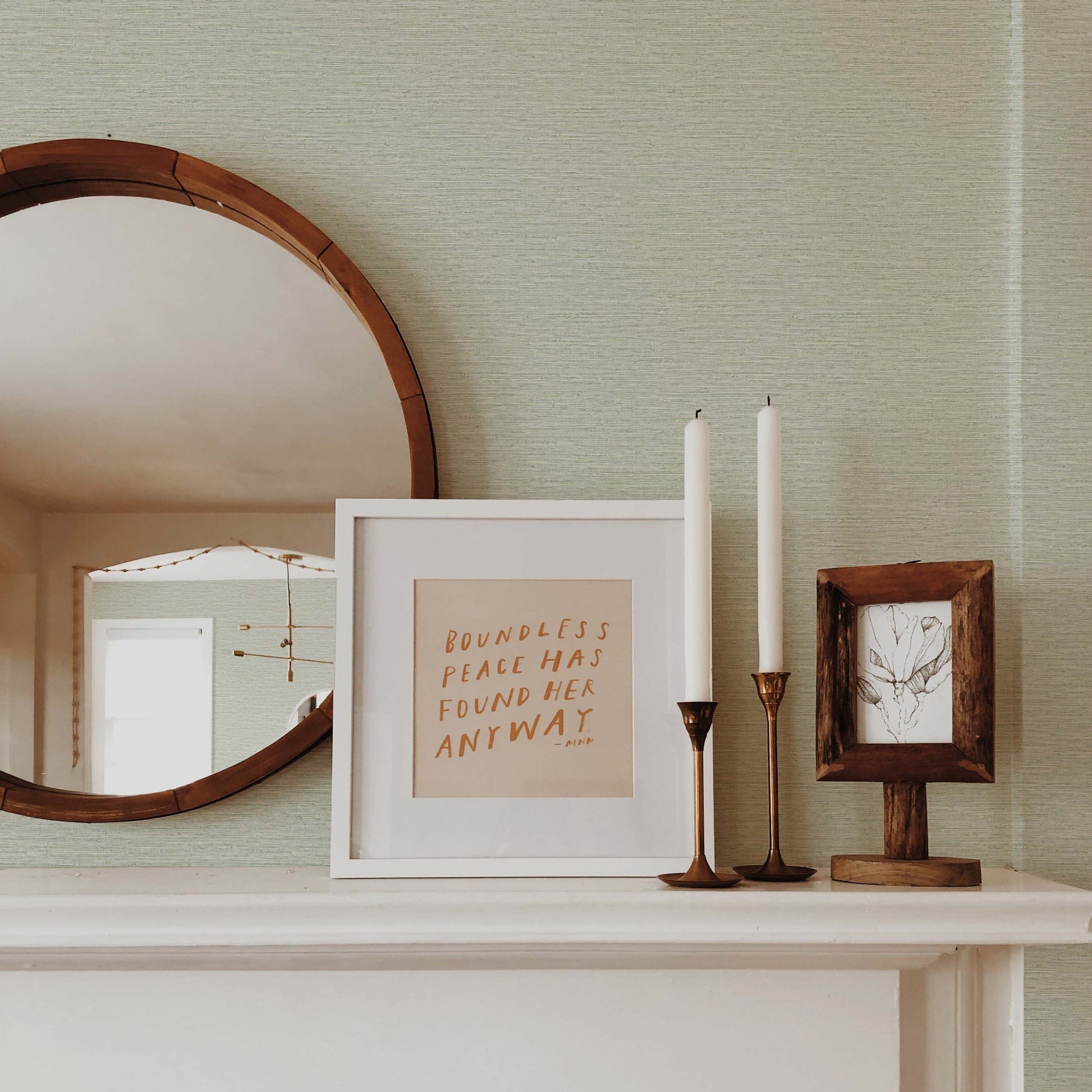 A mantel with decor pops against light green Texture Grasscloth Effect Commercial Vinyl, creating a cozy modern vibe.