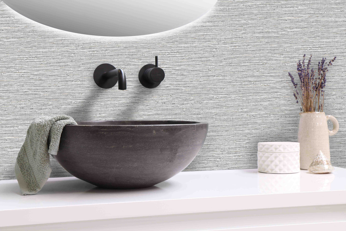 Modern bathroom sink with a towel, lavender vase, and containers beside Texture Grasscloth Effect Commercial Vinyl.