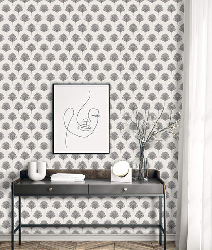 Minimalist desk with abstract face art, vase, decor, and Indian Botanical Commercial Vinyl wallpaper.