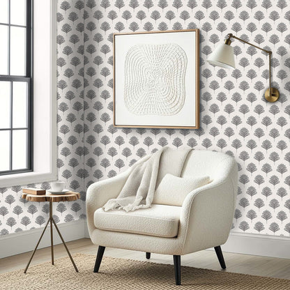 Cozy armchair, round table, and abstract art set against Indian Botanical Commercial Vinyl wallpaper in a modern corner.