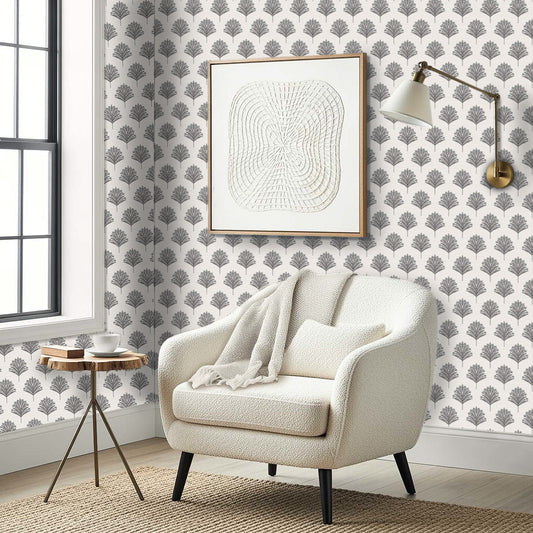 Cozy armchair, round table, and abstract art set against Indian Botanical Commercial Vinyl wallpaper in a modern corner.