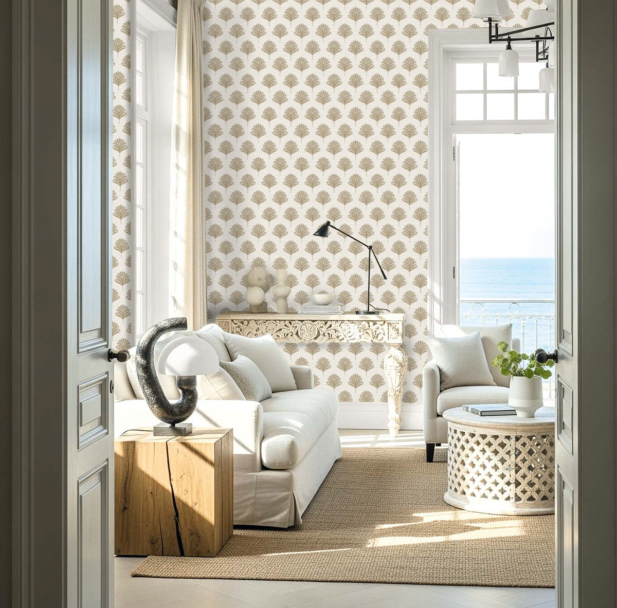 Bright coastal living room with Indian Botanical Commercial Vinyl wallpaper, white furniture, and sea-view windows.