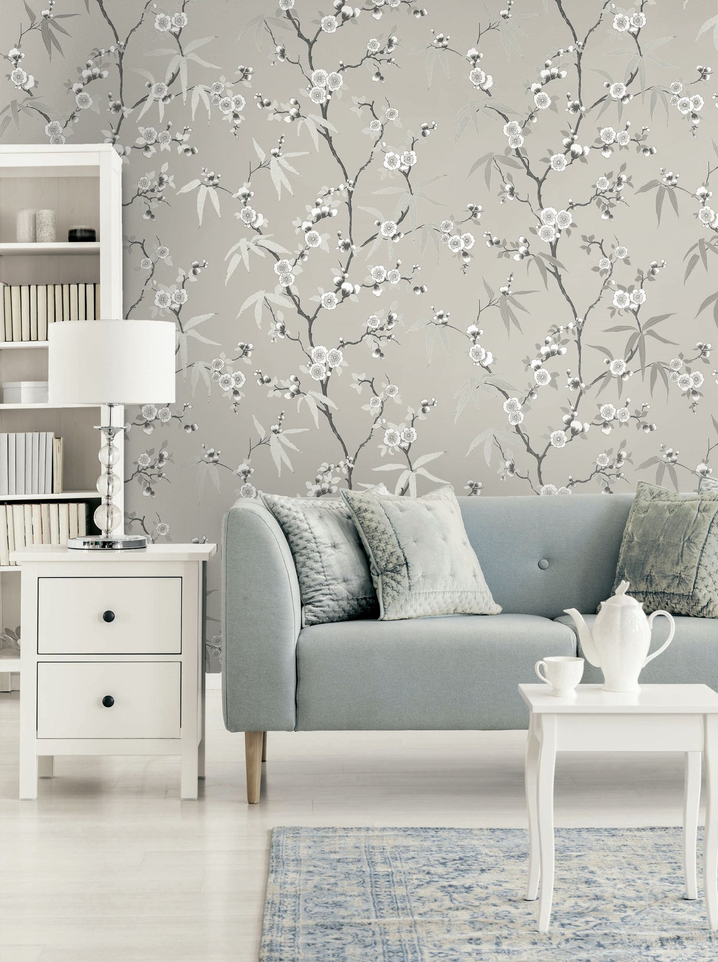 Living room with gray sofa, white coffee table, and Gray Blossom Spring Flower Wallpaper.
