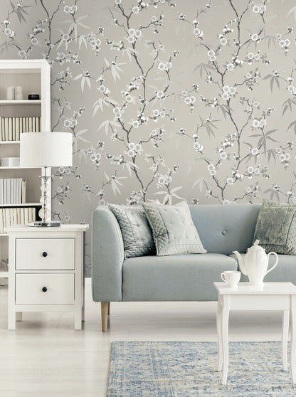 Living room with gray sofa, white coffee table, and Gray Blossom Spring Flower Wallpaper.
