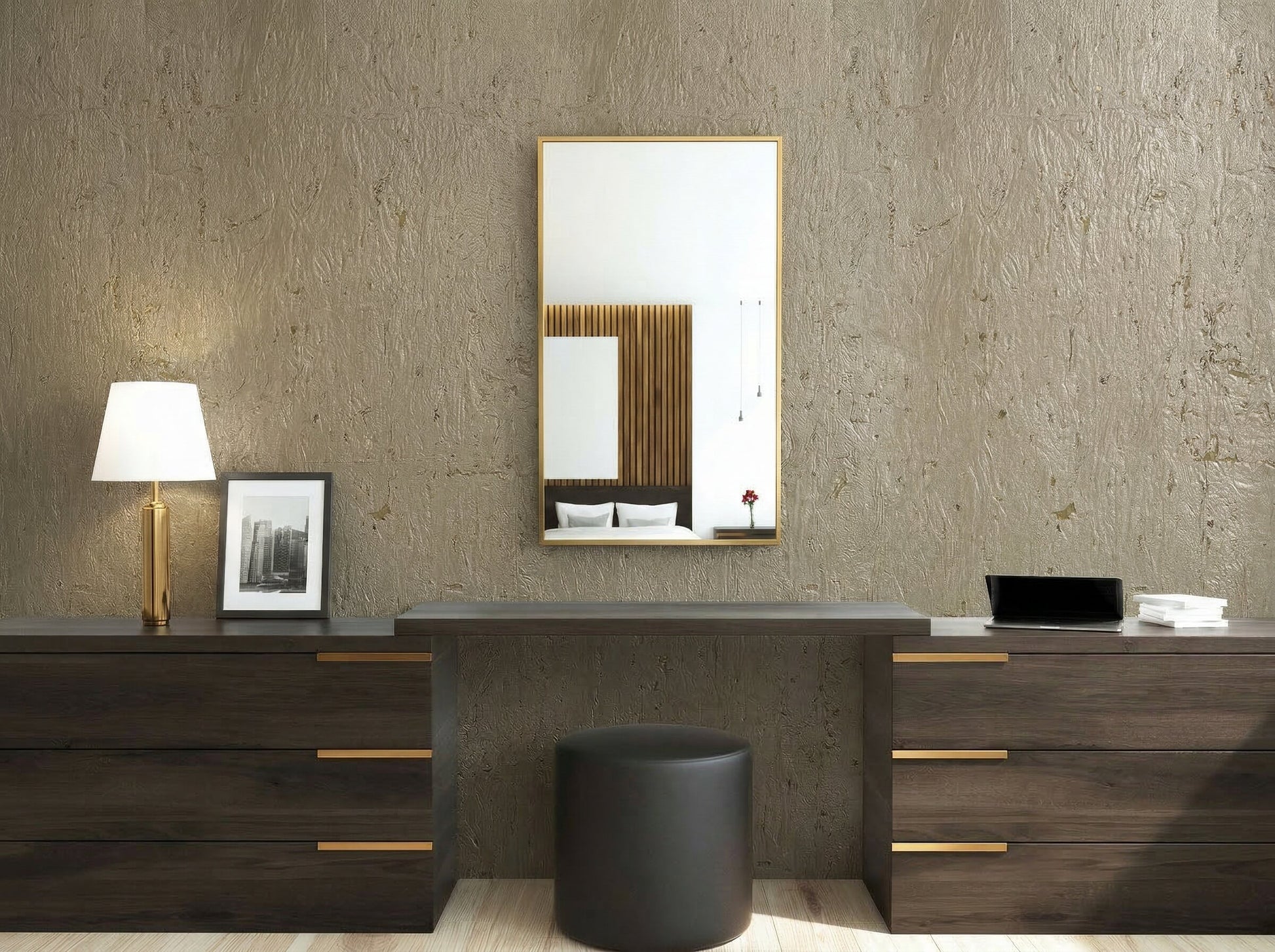 Modern vanity setup with dark wood drawers, lamp, mirror, black stool, and Algarve Cork Grasscloth Naturals wallpaper.