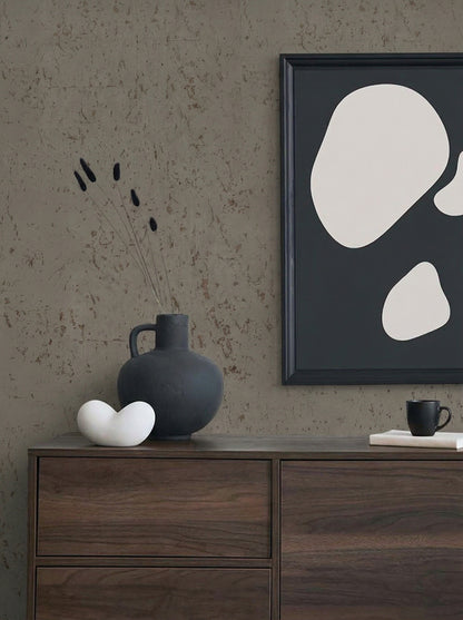 Minimalist decor with abstract art, Algarve Cork Grasscloth Naturals, black vase with stems, stone, cup, and book.