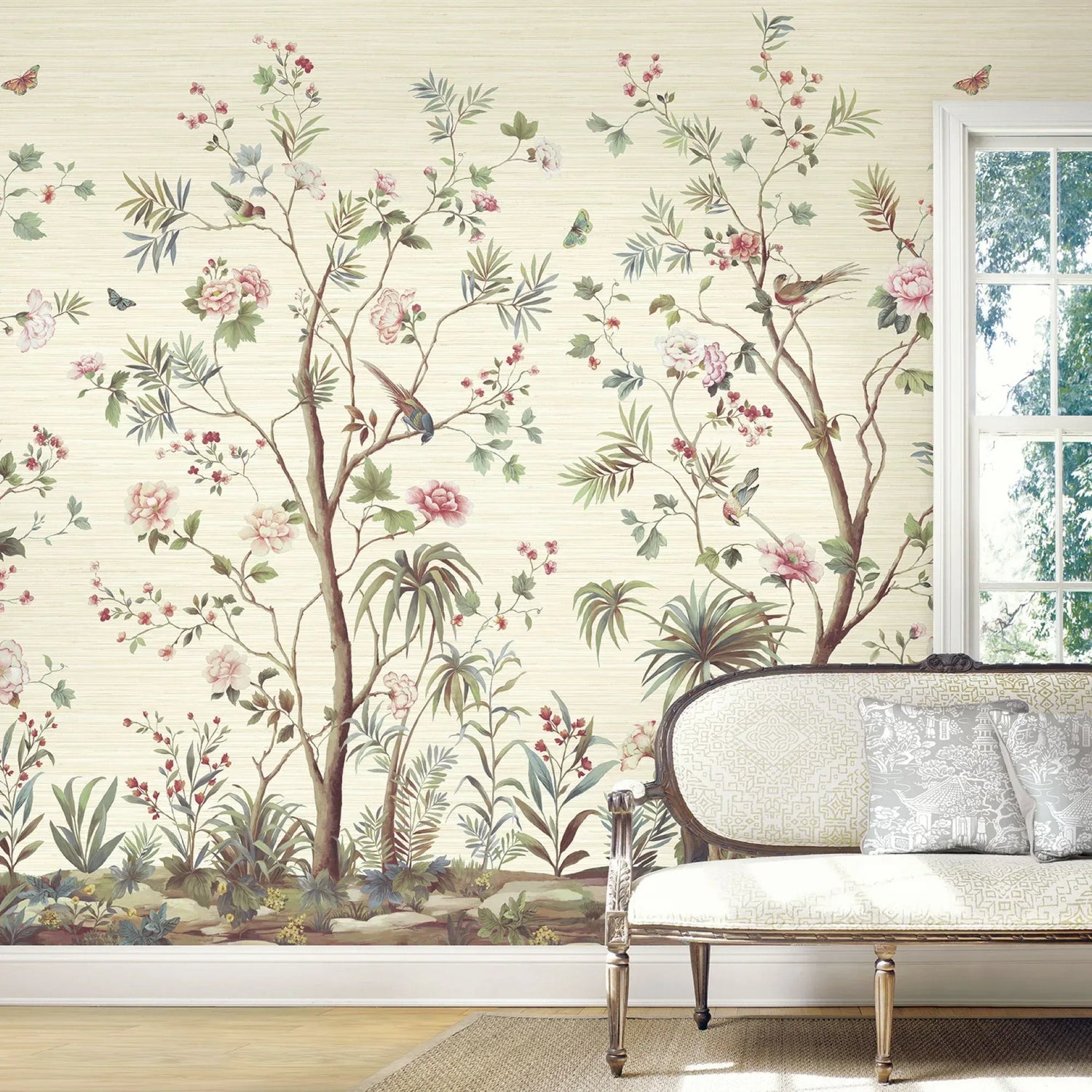 The Garden Floral Murals brighten the space behind a vintage sofa near a sunlit window.