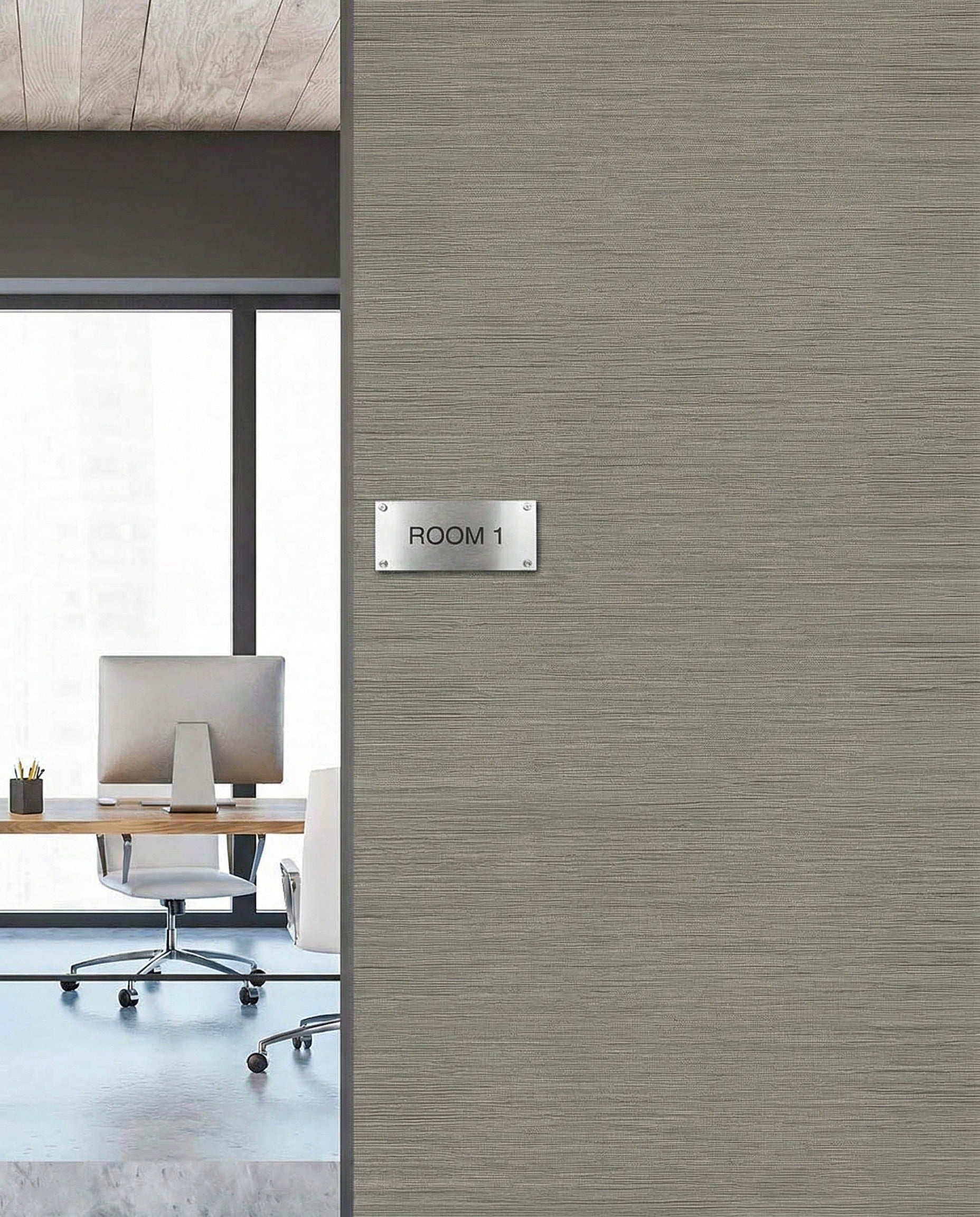 Office with modern furniture seen through Room 1 door, featuring Grasslands Commercial Vinyl wallcovering.
