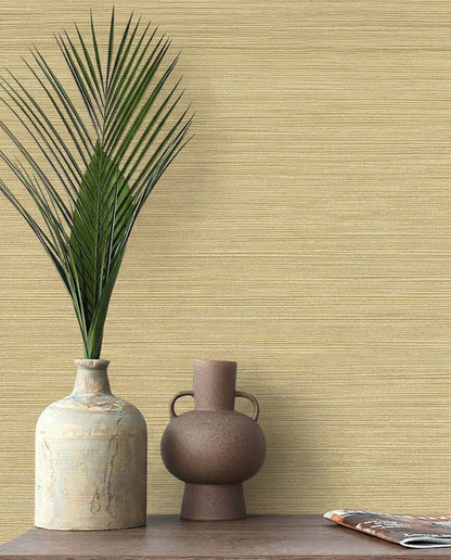 Two ceramic vases, one with a palm leaf, sit on wood against Grasslands Commercial Vinyl wallpaper.