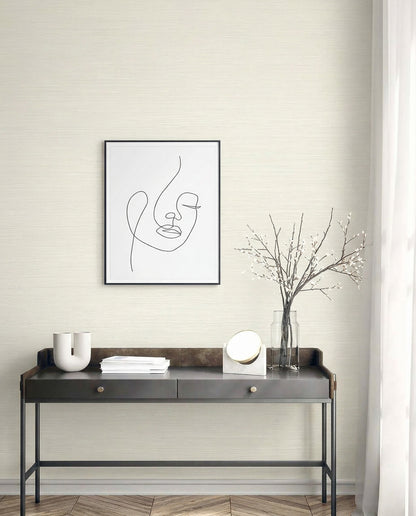 Minimalist desk with decor, framed abstract face art, and Grasslands Commercial Vinyl wallcovering by window.