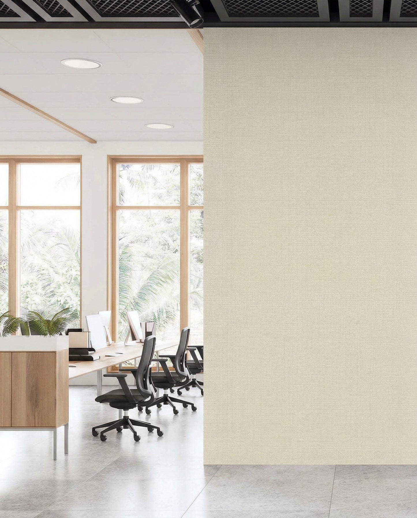 Modern office with desks by large windows; right beige wall features Natural Raffia Commercial Vinyl.