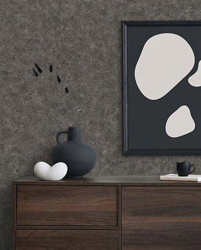 Minimalist decor with Florence Leather Commercial Vinyl wallpaper, dark vase, white sculpture, and art on a dresser.