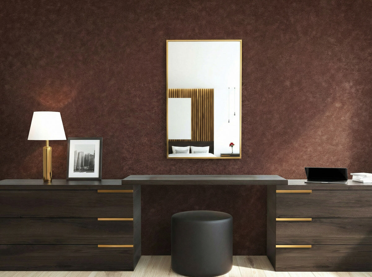 Modern vanity with a round stool, mirror, and Florence Leather Commercial Vinyl on a textured brown wall.