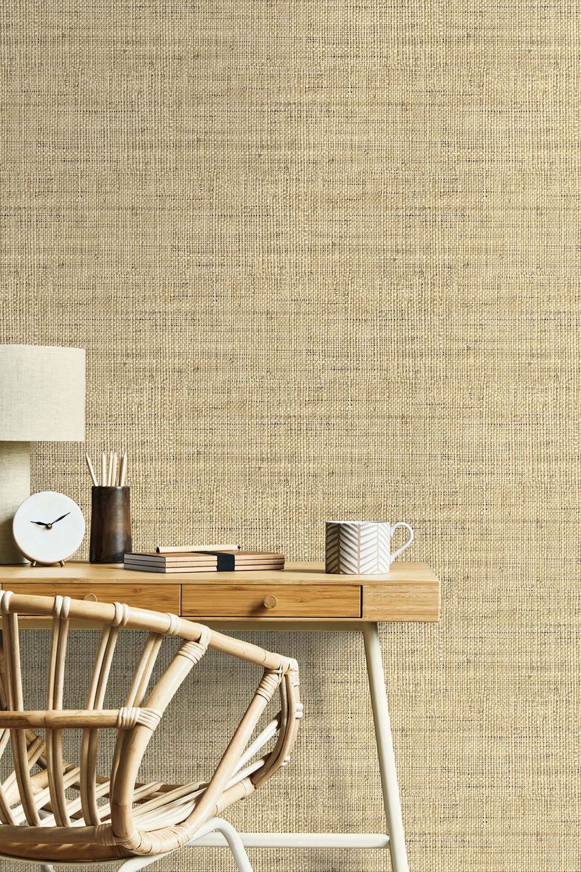 Wheat Beige Linen Fabric Commercial & Vinyl textured wallpaper with a wooden desk and chair in the foreground.