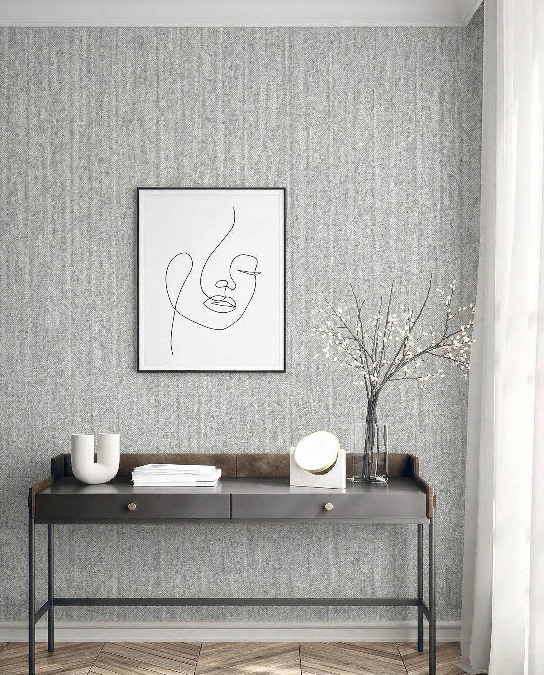 Minimalist desk with decor, vase, and art set against Faux Paperweave Commercial Vinyl wallpaper on a textured wall.