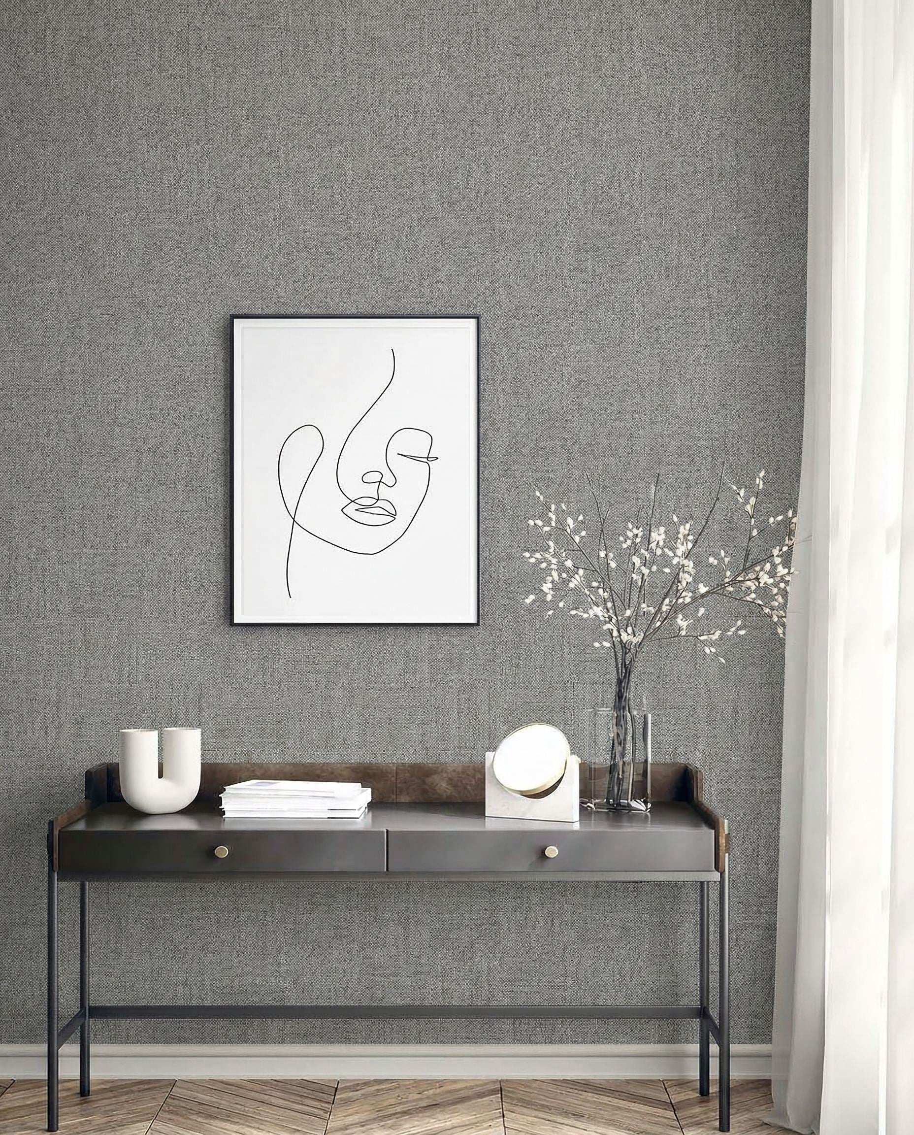 Minimalist console table with decor beneath framed abstract line art on Faux Paperweave Commercial Vinyl wallpaper.