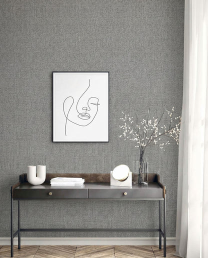 Minimalist console table with decor beneath framed abstract line art on Faux Paperweave Commercial Vinyl wallpaper.
