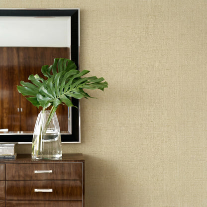 Glass vase with green leaves on a dresser, mirror on Faux Paperweave Commercial Vinyl wallpaper.
