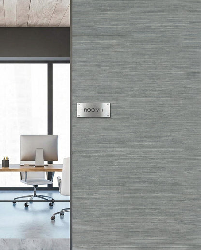 A modern office with a desk and chair is seen through a Room 1 doorway on Sisal Texture Grasscloth Naturals wallpaper.
